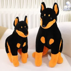 Peluche chien doberman noir et marron assis