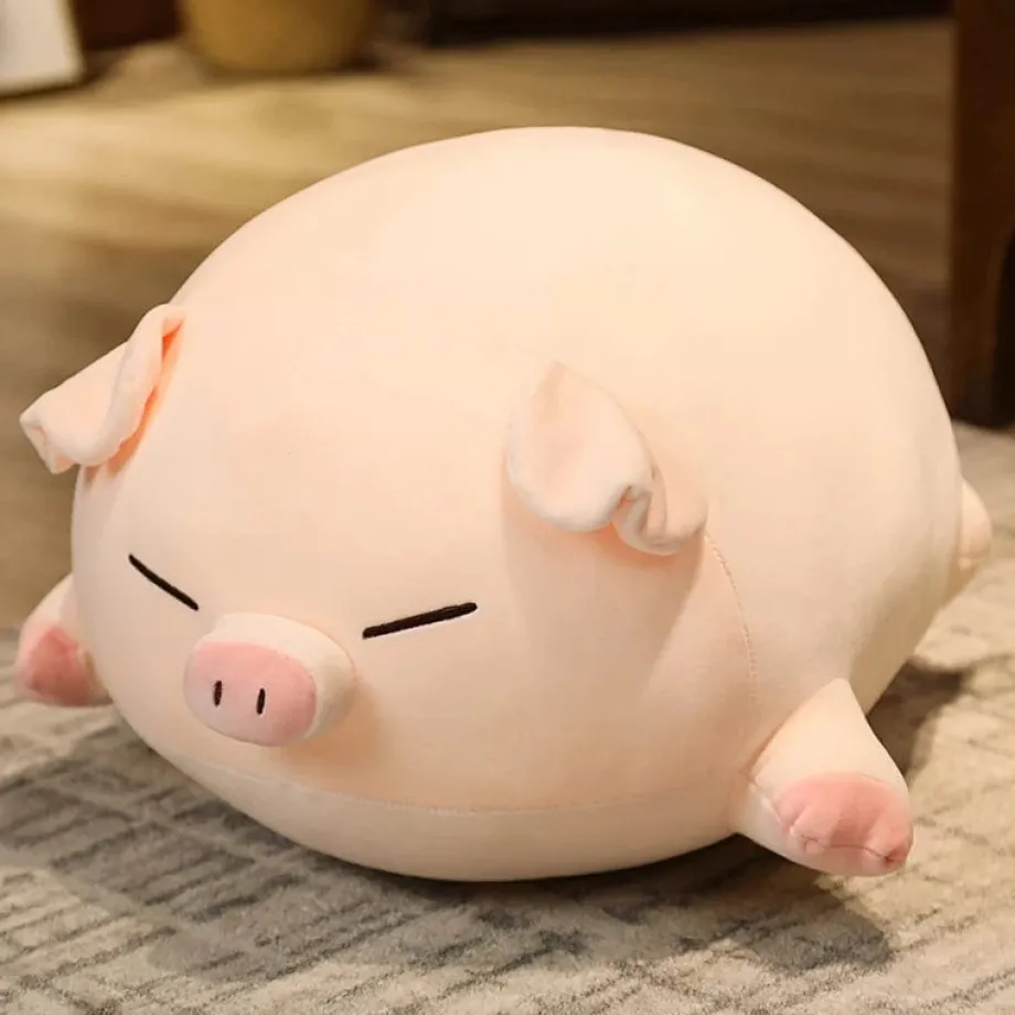 Peluche cochon allongé aux yeux fermés