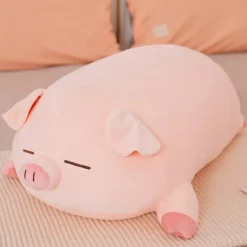 Peluche cochon rose allongé qui dort