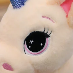 Peluche licorne avec des étoiles dans les yeux