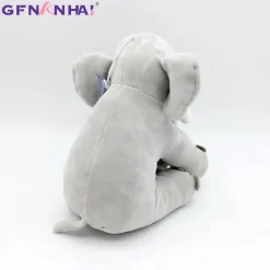 Peluche éléphant assis et content