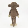 Peluche singe curieuse et attachante
