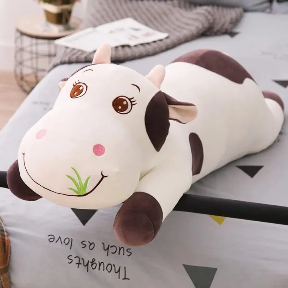 Peluche vache coloré qui broute de l'herbe