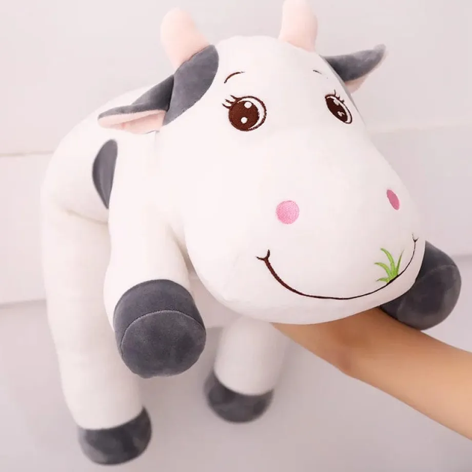 Peluche vache coloré qui broute de l'herbe